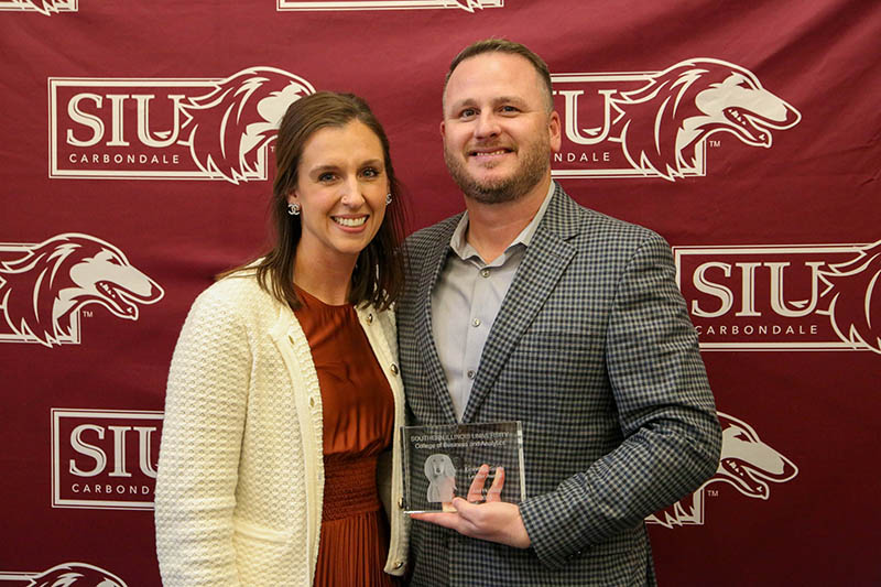 Joel Hundelt holds award